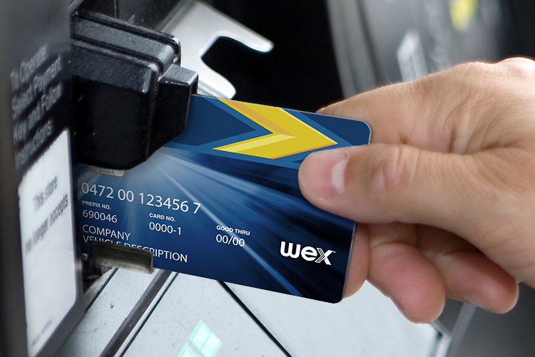 Male hand inserting credit card at gas pump