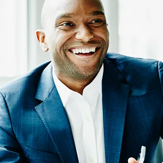 A man wearing a business suit at a corporate job