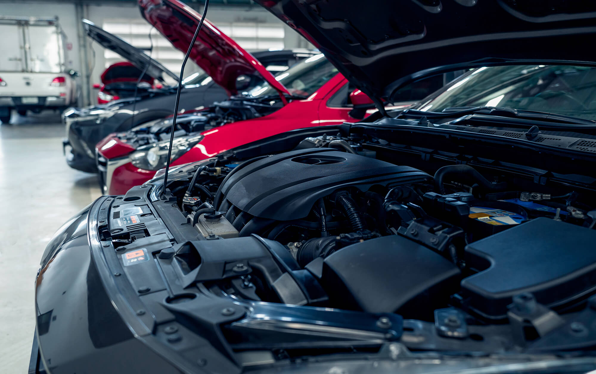 Cars open bonnet parked in garage for repair and maintenance service.