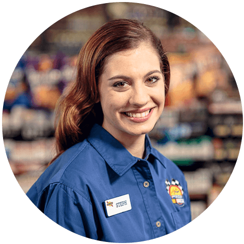 A woman in a Sunoco shirt at a gas station