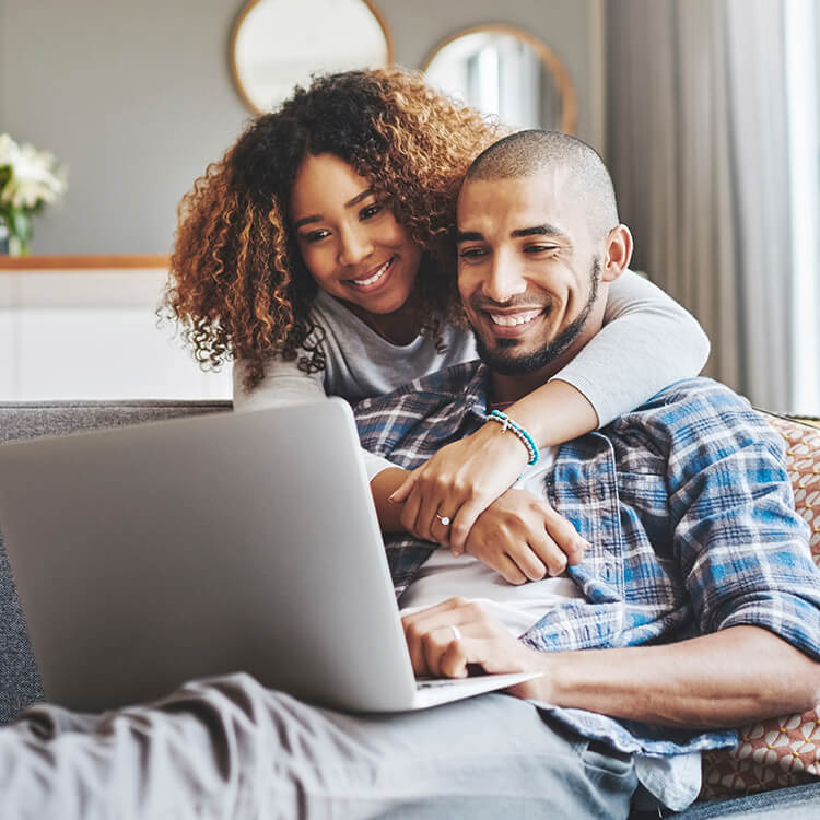 Man with companion looking at laptop