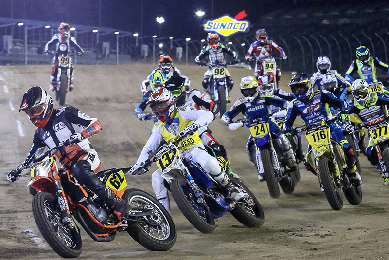 Several riders on dirt bikes during a racing event