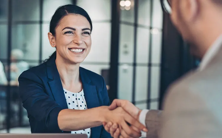 Woman shaking hands with man during interview