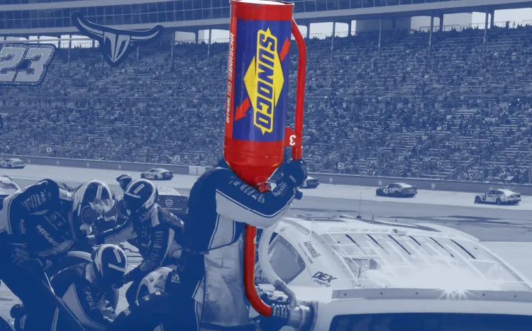 Pit crew filling up race car gas tank