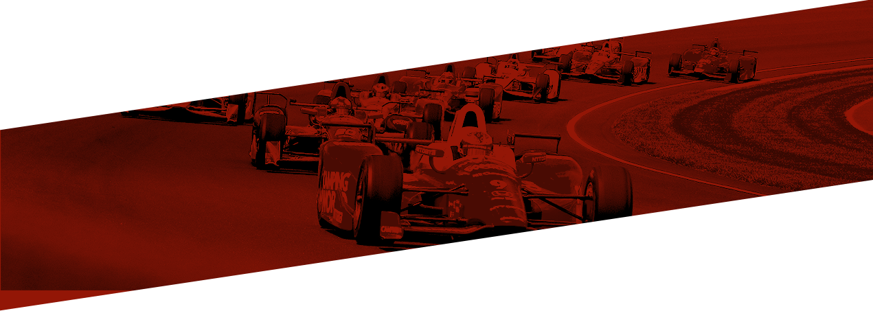 Race cars making a turn around a race track